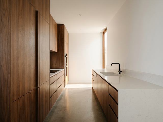 A walnut and white quartz kitchen